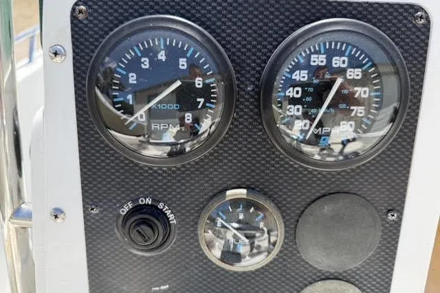 Slide: The Image of Dashboard of a 2000 Robalo 1820 Center Console boat with gauges and controls. - 16