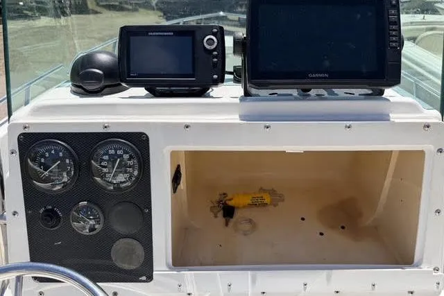 Slide: The Image of Console of 2000 Robalo 1820 Center Console boat with gauges and Garmin electronics. - 13