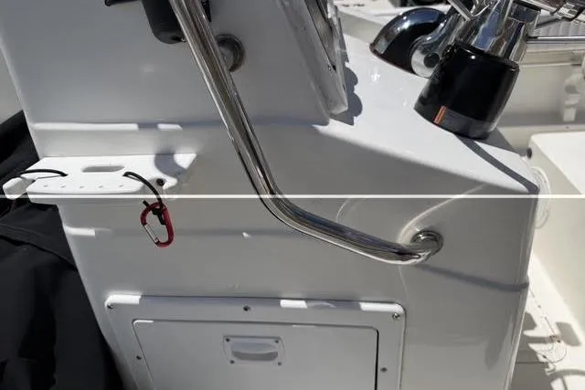 Slide: The Image of 2000 Robalo 1820 Center Console boat dashboard with steering wheel and controls. - 15