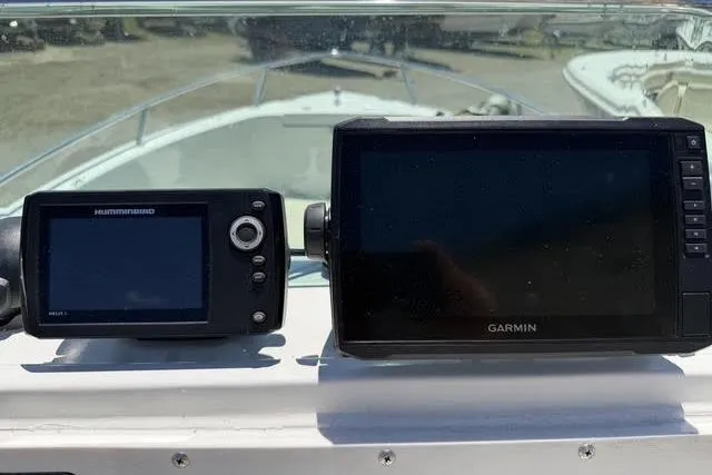 Slide: The Image of Humminbird and Garmin navigation systems on 2000 Robalo 1820 Center Console boat dashboard. - 14