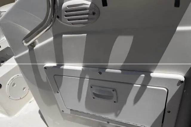 Slide: The Image of 2000 Robalo 1820 Center Console boat interior with storage compartment and handle. - 19