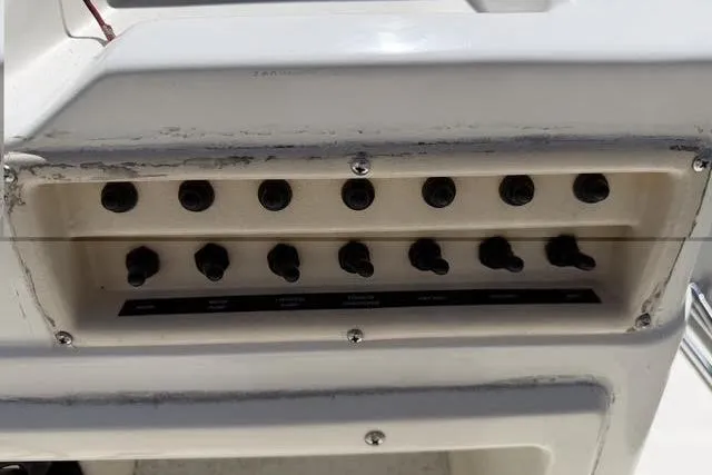 Slide: The Image of Control panel of a 2000 Robalo 1820 Center Console boat with multiple switches. - 17