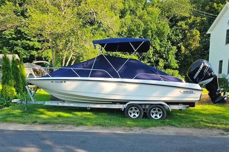 Slide: The Image of 2011 Boston Whaler 230 Dauntless boat on trailer with blue cover and canopy. - 5