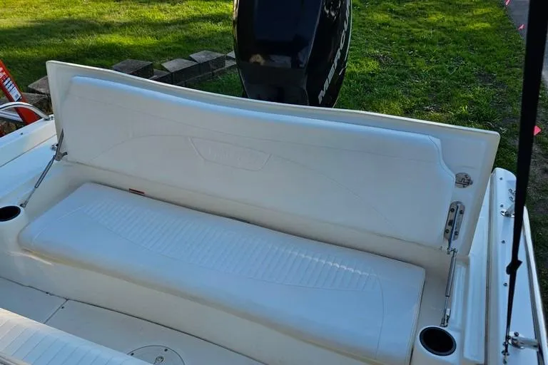Slide: The Image of 2011 Boston Whaler 230 Dauntless boat seat with Mercury engine in background. - 17