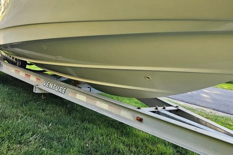 Slide: The Image of 2011 Boston Whaler 230 Dauntless boat on Venture trailer, side view. - 2