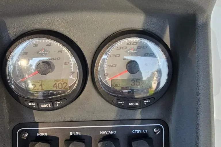Slide: The Image of Dashboard of a 2011 Boston Whaler 230 Dauntless boat showing gauges and switches. - 8