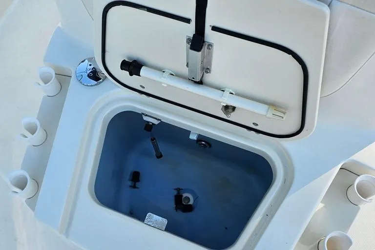 Slide: The Image of Open storage compartment on a 2011 Boston Whaler 230 Dauntless boat. - 15