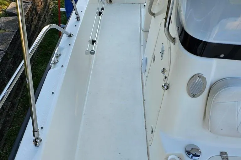 Slide: The Image of 2011 Boston Whaler 230 Dauntless boat deck with stainless steel railings and seating. - 19
