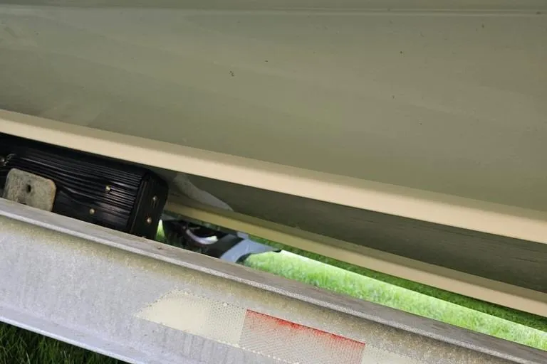 Slide: The Image of Close-up of a 2011 Boston Whaler 230 Dauntless boat hull on a trailer. - 4