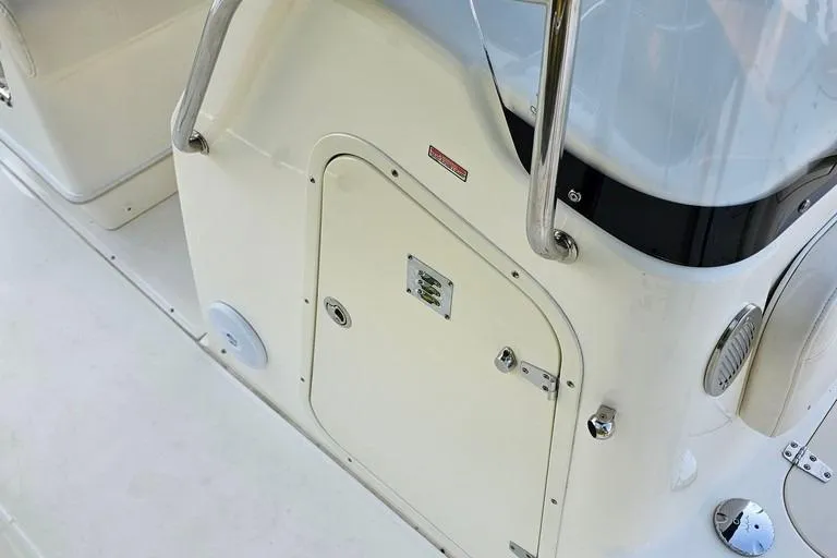 Slide: The Image of 2011 Boston Whaler 230 Dauntless boat console with storage compartment and stainless steel railing. - 20