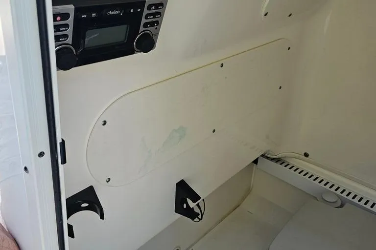 Slide: The Image of Interior view of a 2011 Boston Whaler 230 Dauntless boat with a Clarion stereo system. - 11