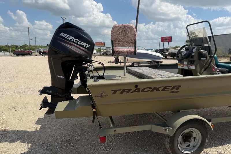 Slide: The Image of 2013 Tracker Grizzly 1860 CC boat with Mercury outboard motor on trailer. - 4