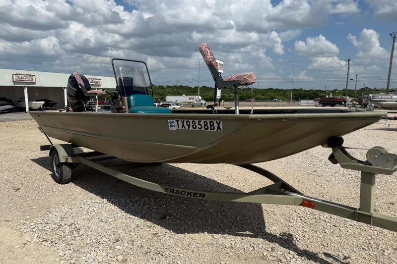 Slide: The Image of 2013 Tracker Grizzly 1860 CC boat on trailer under cloudy sky. - 5