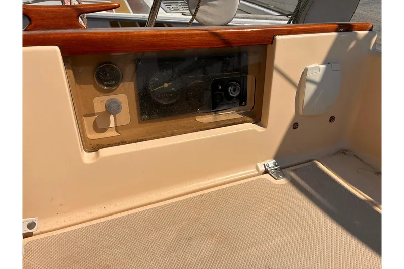 Slide: The Image of 1991 Island Packet 29 sailboat cockpit with instrument panel and wooden trim. - 19