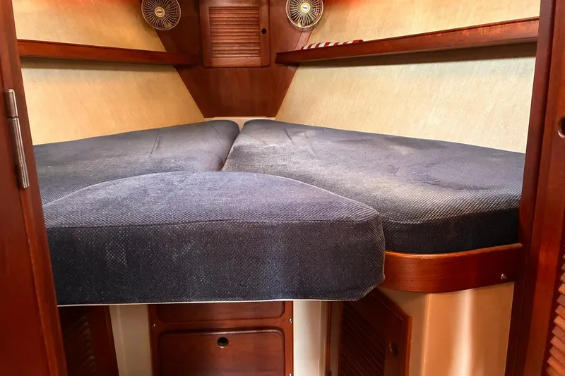Slide: The Image of Interior cabin of a 1991 Island Packet 29 sailboat with cozy bedding. - 25