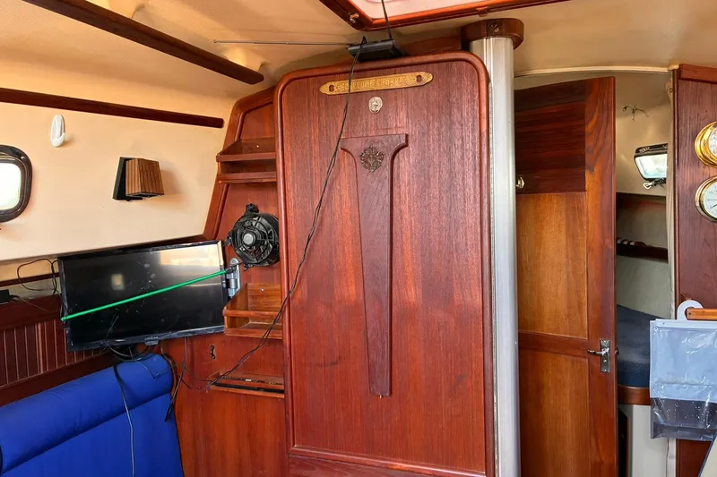 Slide: The Image of Interior of a 1991 Island Packet 29 sailboat with wooden cabinetry and seating. - 23