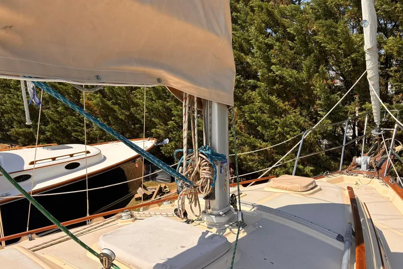 Slide: The Image of Sailboat deck of 1991 Island Packet 29 with rigging and trees in background. - 6
