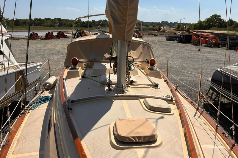 Slide: The Image of 1991 Island Packet 29 sailboat on land, surrounded by other boats and construction equipment. - 7