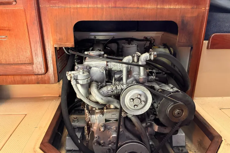 Slide: The Image of Engine compartment of a 1991 Island Packet 29 sailboat, showcasing mechanical components. - 31