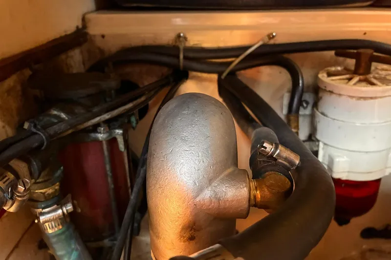 Slide: The Image of Engine compartment of a 1991 Island Packet 29 sailboat, showing hoses and fittings. - 33
