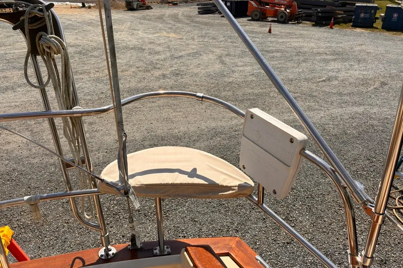 Slide: The Image of 1991 Island Packet 29 sailboat cockpit with stainless steel railings and ropes. - 14