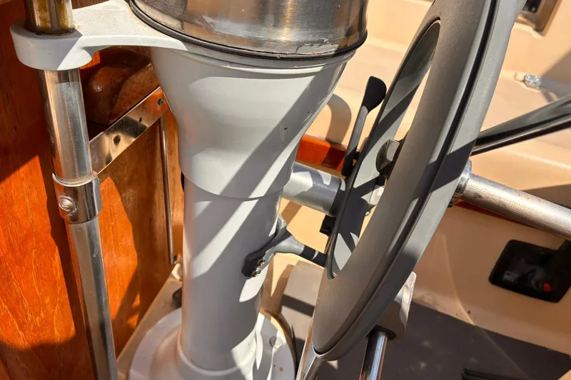 Slide: The Image of Steering wheel of a 1991 Island Packet 29 sailboat, showcasing nautical craftsmanship. - 16