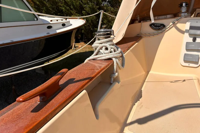 Slide: The Image of 1991 Island Packet 29 sailboat deck with winch and coiled rope. - 17