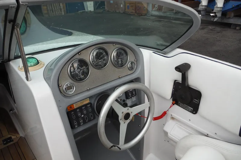 Slide: The Image of 2008 Chris-Craft Launch 25 boat dashboard with steering wheel and instrument panel. - 12