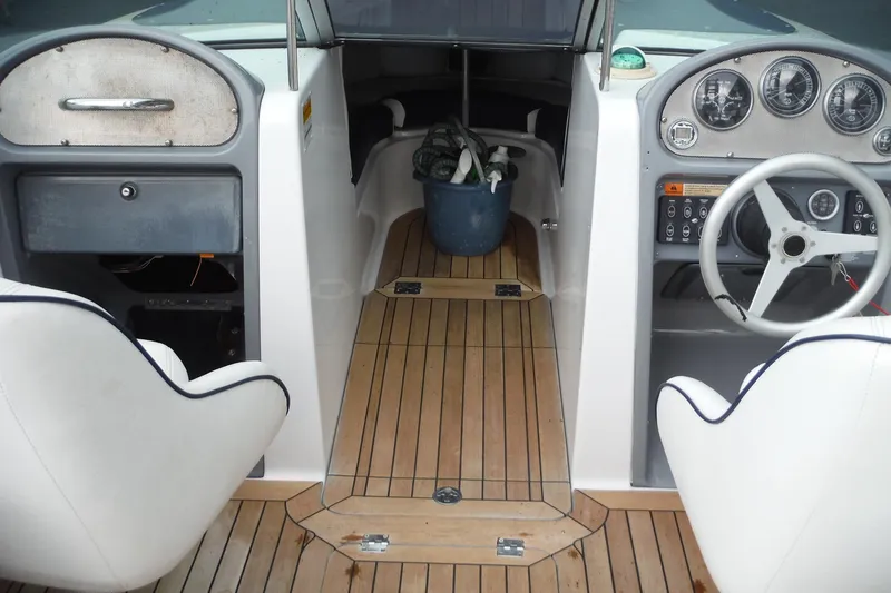Slide: The Image of 2008 Chris-Craft Launch 25 boat interior with wooden flooring and steering wheel. - 7
