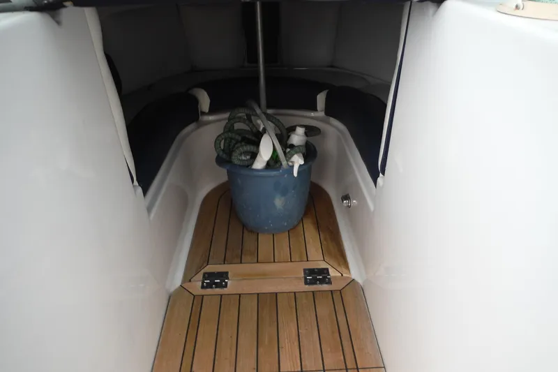 Slide: The Image of 2008 Chris-Craft Launch 25 interior with wooden flooring and cleaning supplies in a bucket. - 10
