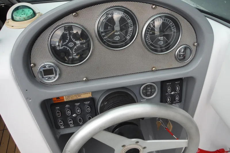 Slide: The Image of Dashboard of a 2008 Chris-Craft Launch 25 boat with gauges and steering wheel. - 11