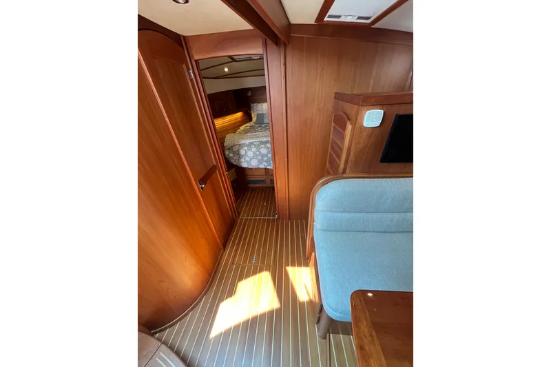 Slide: The Image of Interior of 2018 Sabre 42 Fly Bridge Sedan with wood finish and cozy bedroom. - 32
