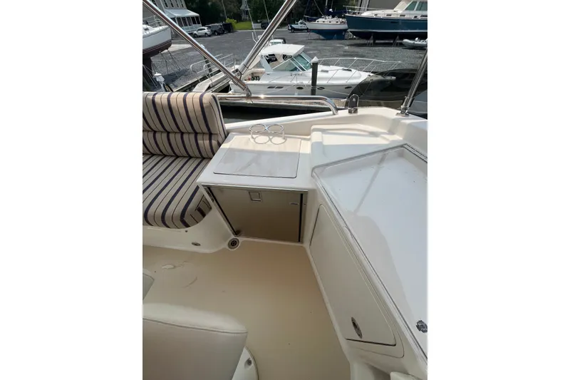 Slide: The Image of 2018 Sabre 42 Fly Bridge Sedan interior with striped seating and storage compartments. - 12