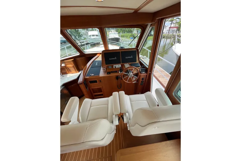 Slide: The Image of Interior of 2018 Sabre 42 Fly Bridge Sedan with helm, Garmin displays, and white seating. - 22
