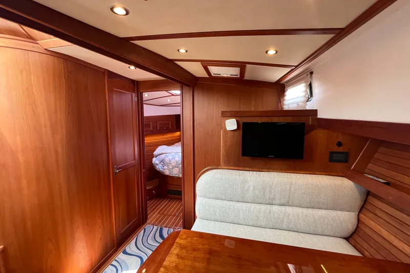 Slide: The Image of Luxurious interior of 2018 Sabre 42 Fly Bridge Sedan with wood paneling and cozy seating. - 30