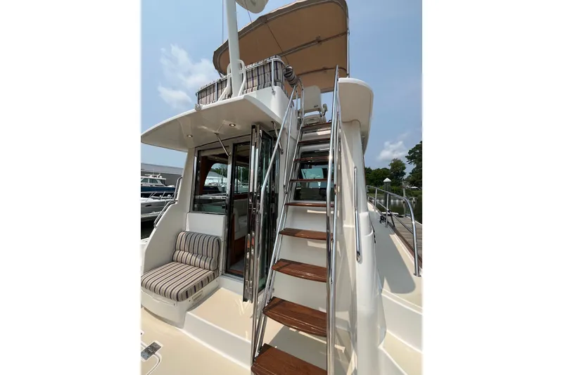 Slide: The Image of 2018 Sabre 42 Fly Bridge Sedan with stairs and seating area. - 7