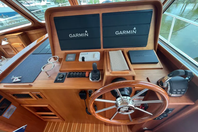 Slide: The Image of Helm of 2018 Sabre 42 Fly Bridge Sedan with Garmin navigation displays and wooden steering wheel. - 23