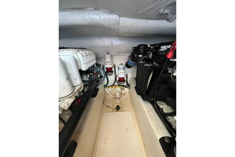 Slide: The Image of Engine room of 2018 Sabre 42 Fly Bridge Sedan, showcasing mechanical components and filters. - 45