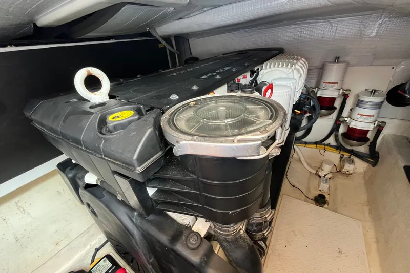 Slide: The Image of Engine room of 2018 Sabre 42 Fly Bridge Sedan with visible components and filters. - 42