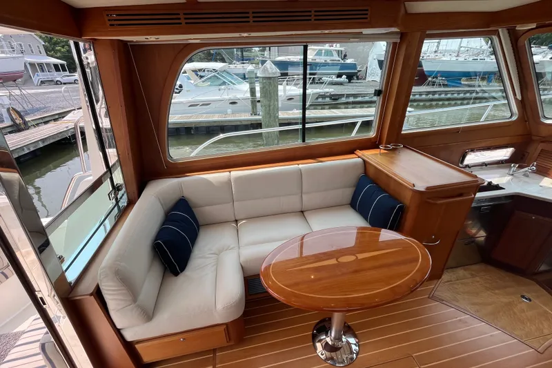 Slide: The Image of Luxurious interior of 2018 Sabre 42 Fly Bridge Sedan with elegant seating and wooden table. - 19