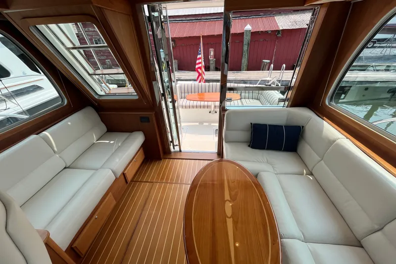 Slide: The Image of Interior of 2018 Sabre 42 Fly Bridge Sedan with elegant seating and wooden table. - 21
