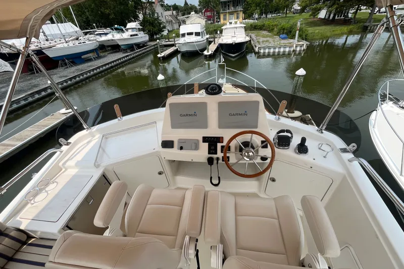 Slide: The Image of Flybridge view of 2018 Sabre 42 Fly Bridge Sedan with Garmin navigation, docked in marina. - 10