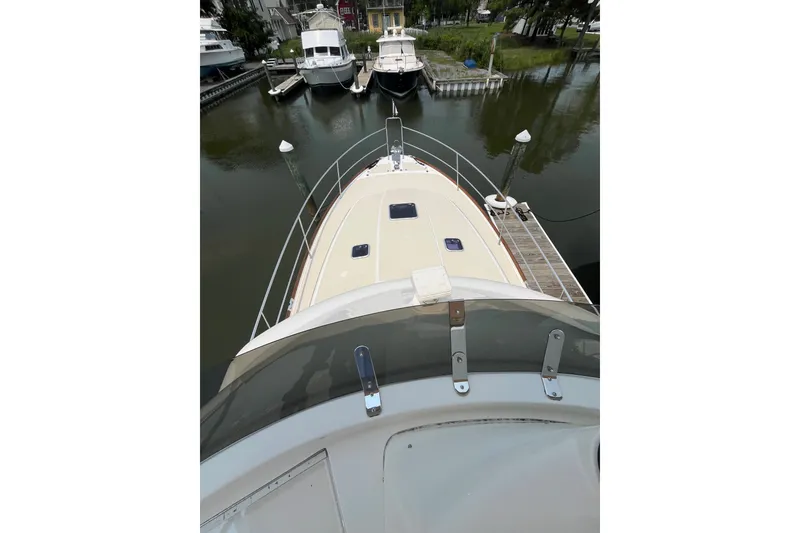 Slide: The Image of 2018 Sabre 42 Fly Bridge Sedan yacht docked at marina, viewed from above. - 13
