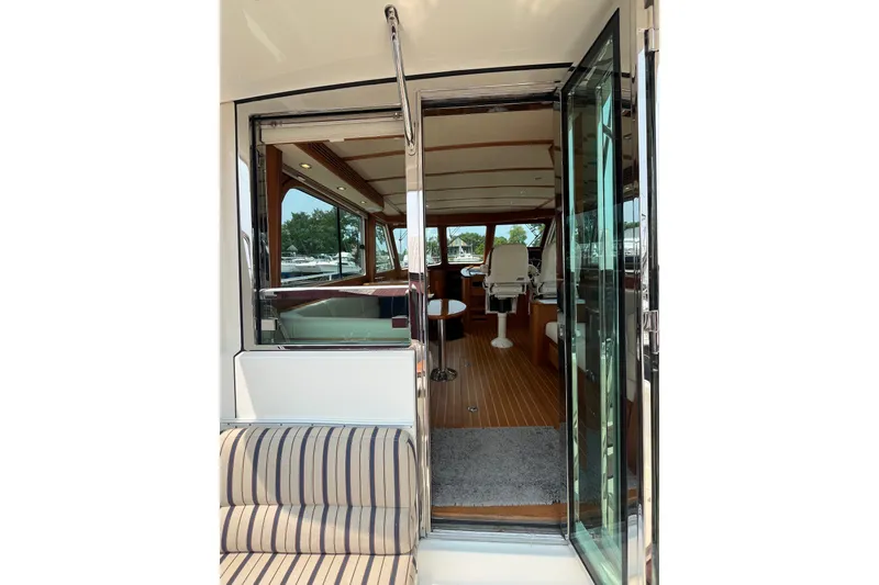 Slide: The Image of Interior view of 2018 Sabre 42 Fly Bridge Sedan yacht through open glass door. - 18