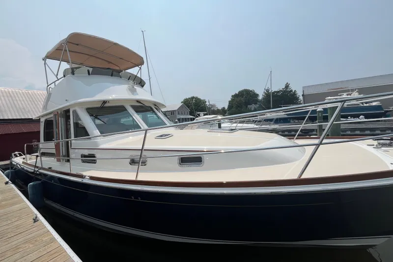 Slide: The Image of 2018 Sabre 42 Fly Bridge Sedan docked at marina, showcasing sleek design and spacious flybridge. - 6