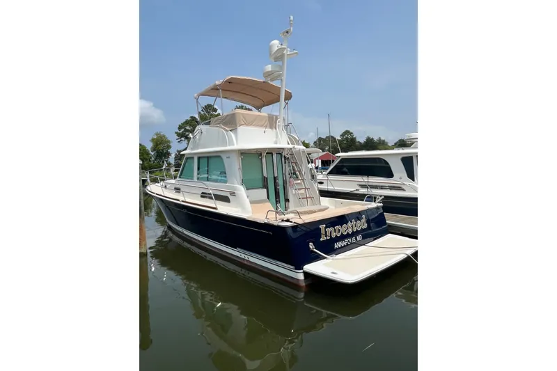 Slide: The Image of 2018 Sabre 42 Fly Bridge Sedan docked, featuring elegant design and spacious flybridge. - 3