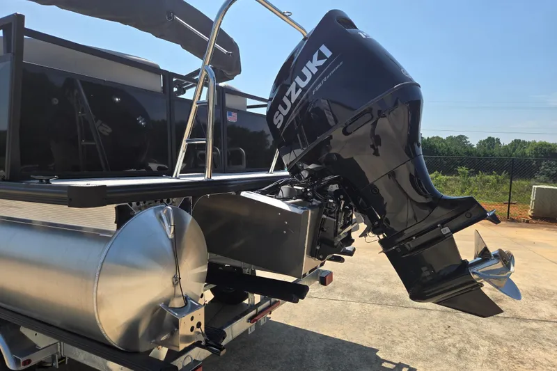 Slide: The Image of Dockside 22DQ275 boat with Suzuki outboard motor, 2026 model, parked outdoors. - 13