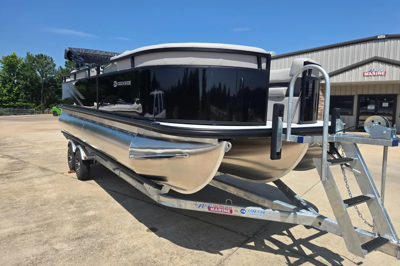 Slide: The Image of 2026 Dockside 22DQ275 pontoon boat on trailer, parked outside a marine dealership. - 5