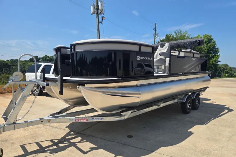 Slide: The Image of 2026 Dockside 22DQ275 pontoon boat on trailer, parked outdoors under clear sky. - 4