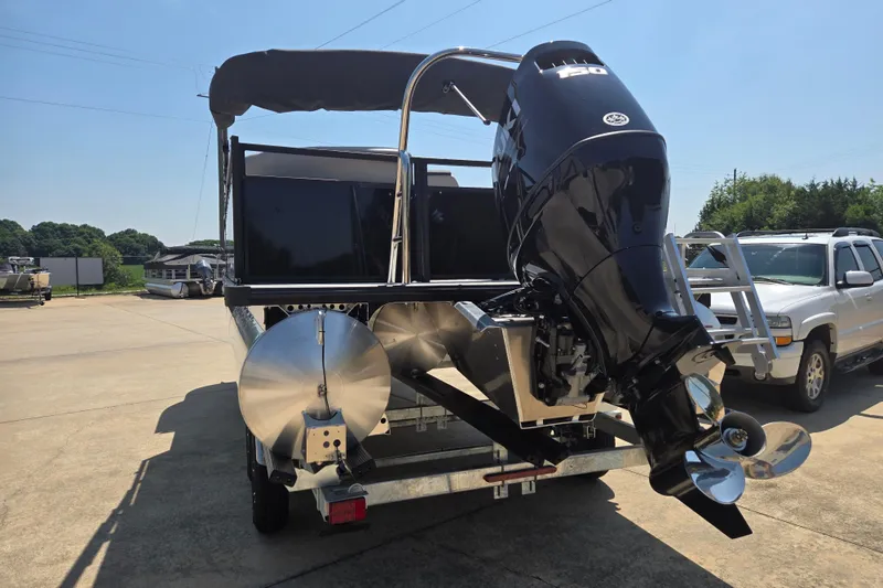Slide: The Image of 2026 Dockside 22DQ275 pontoon boat with powerful outboard motor, parked on a sunny day. - 14